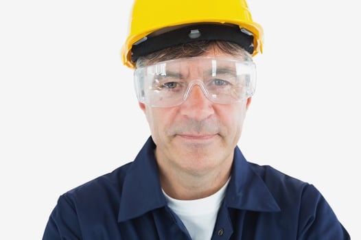 Close-up portrait of mature technician wearing protective glasses and hardhard over white background-1